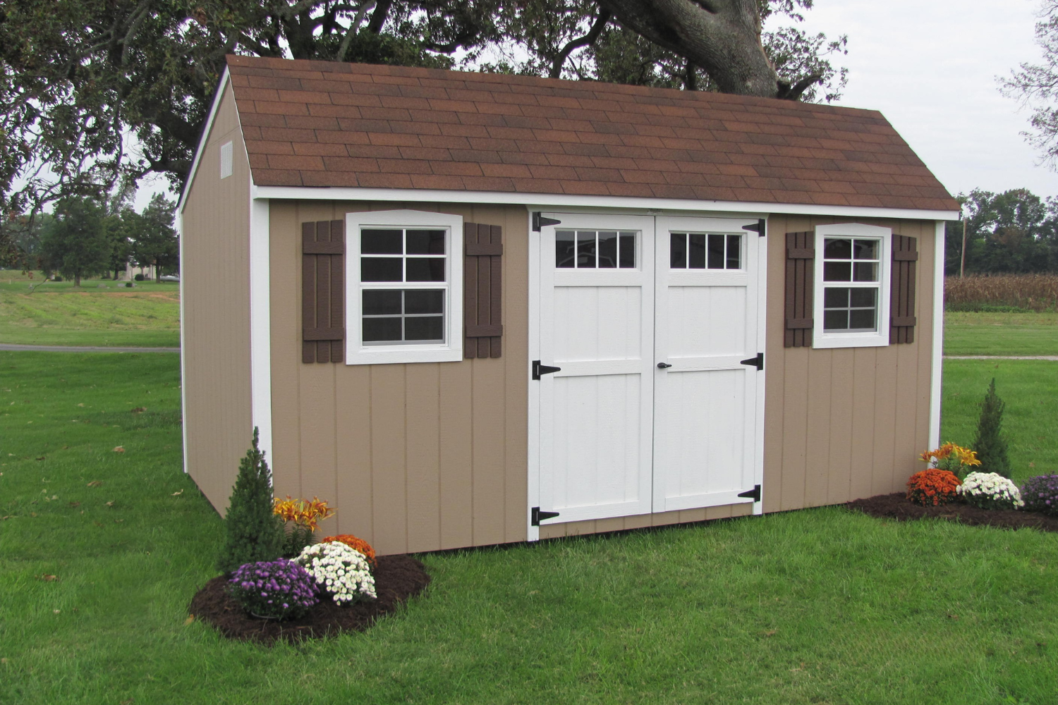 12x14 brown quaker shed with white double doors and windows