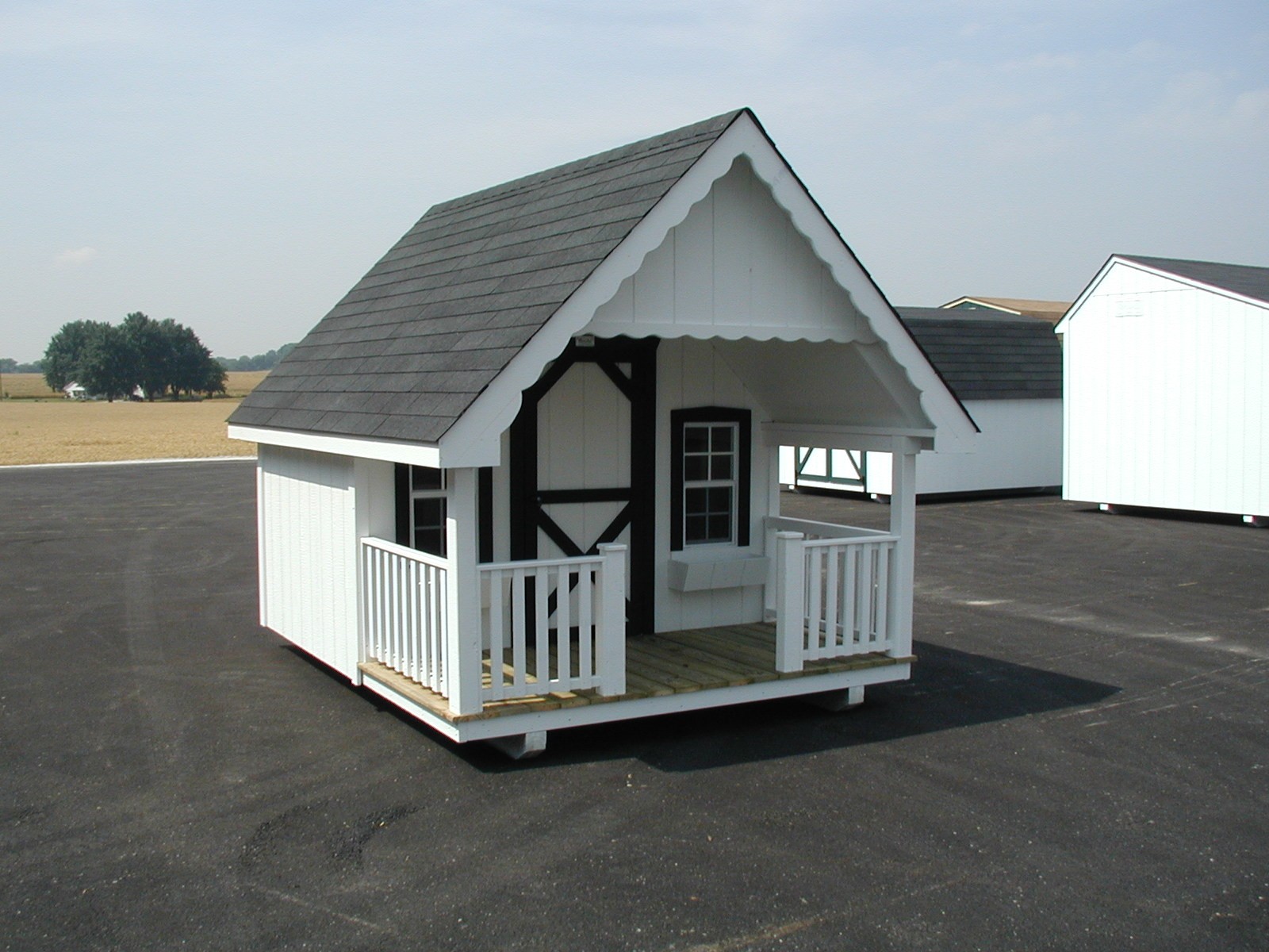 white and black trimmed Backyard playhouse for kids in nashville TN with front porch