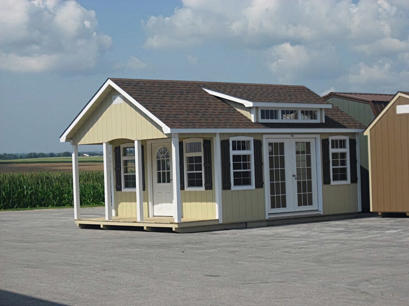 yellow lancaster cabins for sale in Nashville TN with white trim dormer and front porch plus double side doors