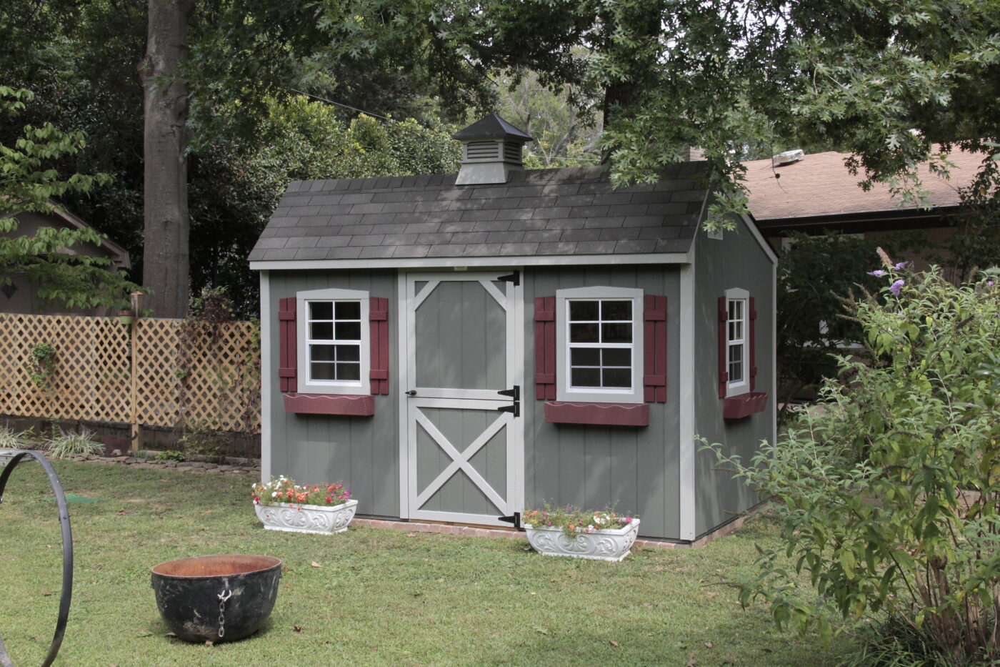 gray and white Quaker sheds for sale in Nashville TN with red shutters and flower boxes and a cupola on the gray shingle roof