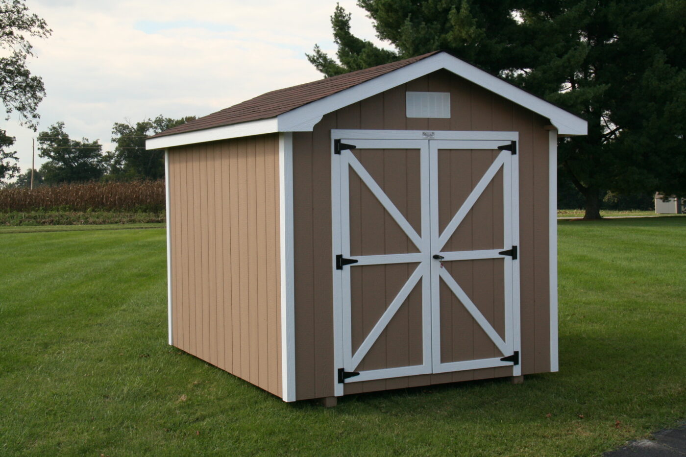simple tan and white trimmed shed