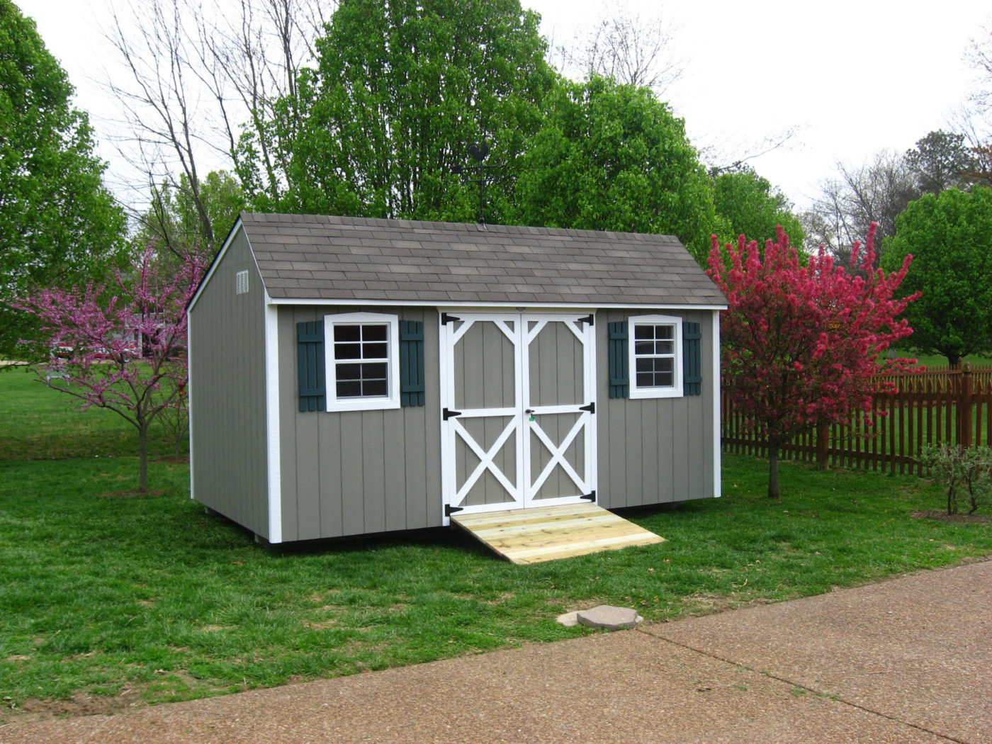 backyard shed with beautiful landscaping scaled
