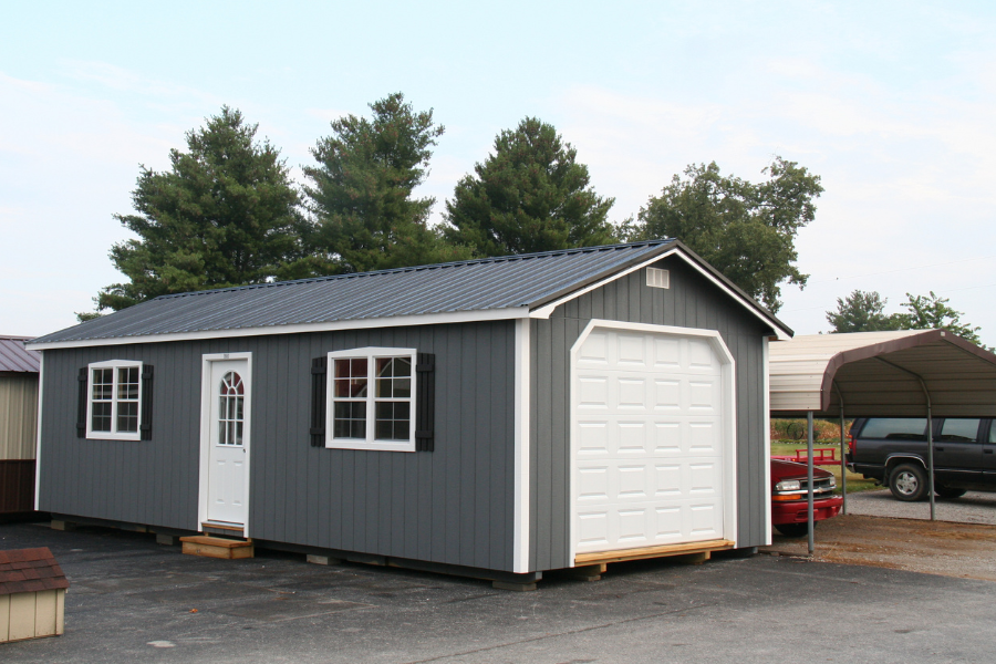 blue and white trimmed one car garage with metal roofing