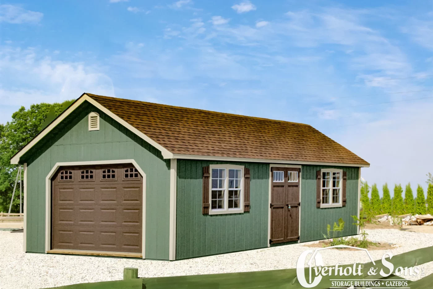 green and tan trimmed lancaster style garage in nashville with brown overhead door and double side doors with transom windows