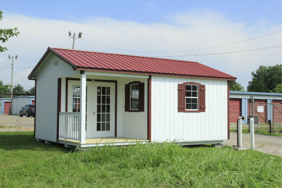 white and red trimmed a frame cabins for sale in Nashville with red metal roof and front porch